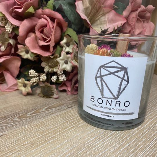 Bonro Gifts  Made with natural soy wax which is all about sustainability;  this wooden wick candle also contains a special jewelry surprise for you to  discover. Once the wick of your